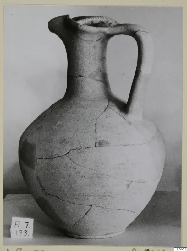 Jug of Pottery Red Slip I_III - V_VII from Amathus, with a strap handle and cracks across the body