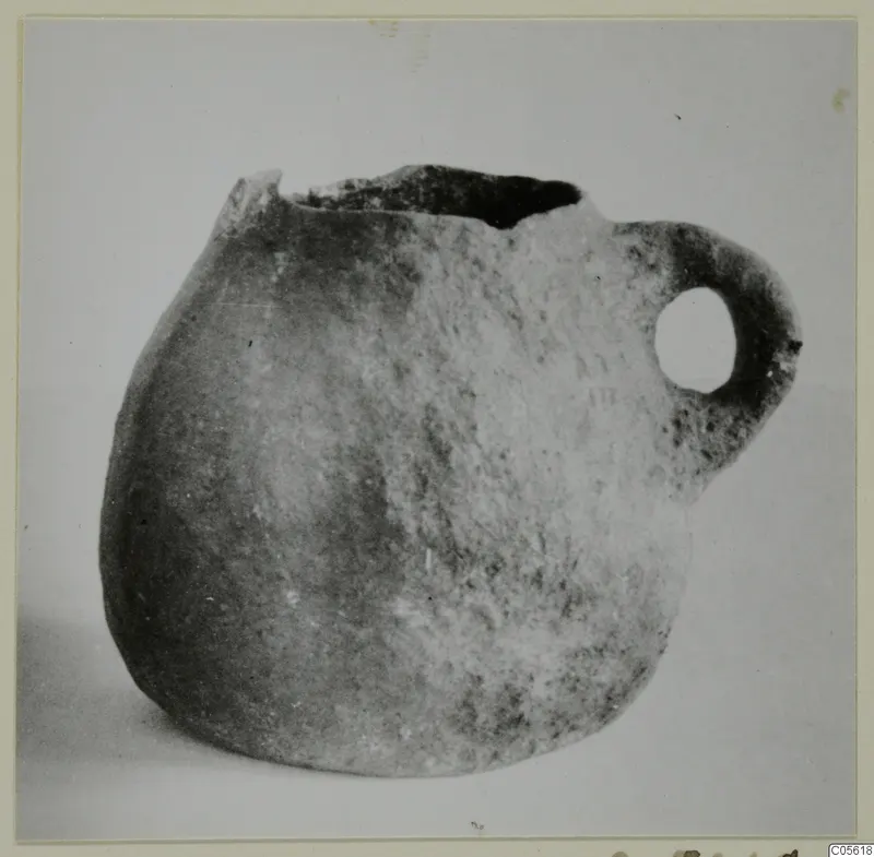 Coarse pottery tankard from Amathus with a rounded body, single loop handle and broken rim.