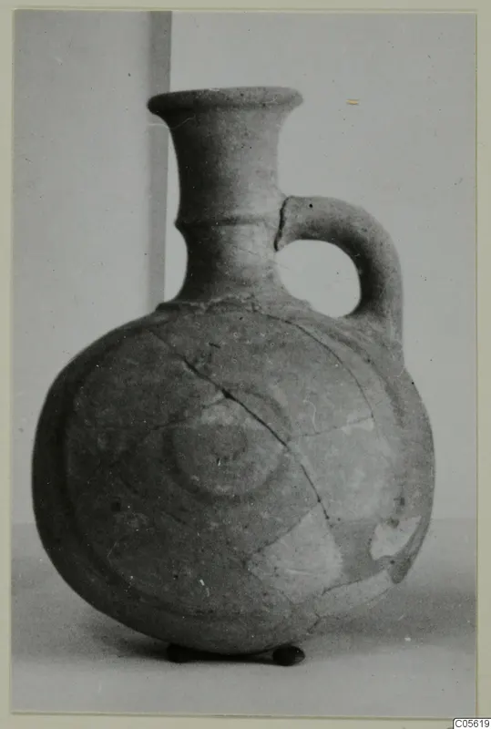 Pottery Polychrome Lustrous Foreign jug with a single loop handle, flared neck and concentric rings on the body
