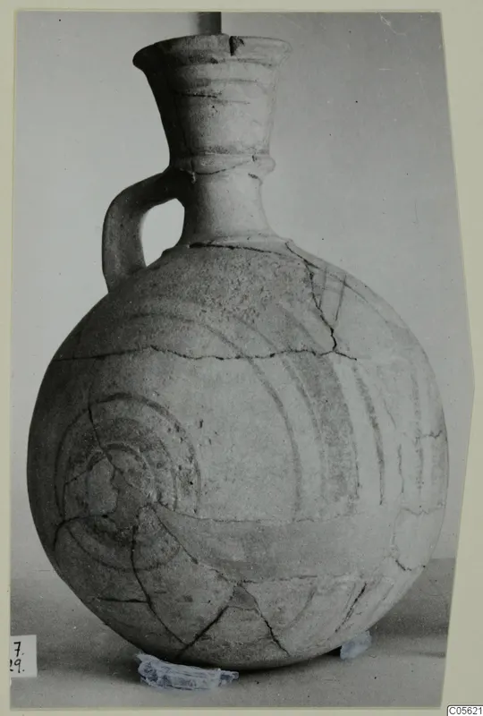 Jug from Amathus with dark painted concentric circles and a loop handle, photographed on a mount