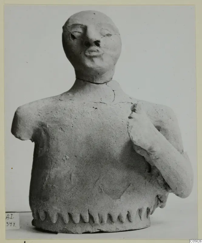 Terracotta bust from Ayia Irini with one arm broken short and the other bent up to the chest