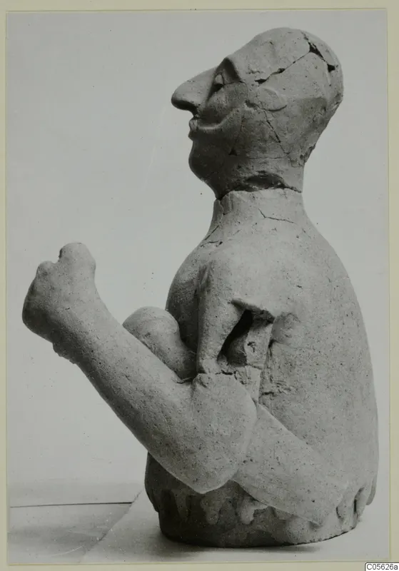 Terracotta Proto-Cypriote I: seated figure in profile, one fist raised, cracked and partly broken