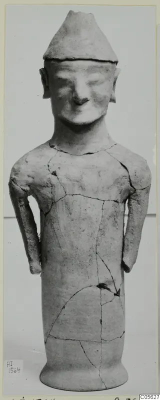 Terracotta statuette of a standing figure with a conical cap and arms at its sides, from Ayia Irini