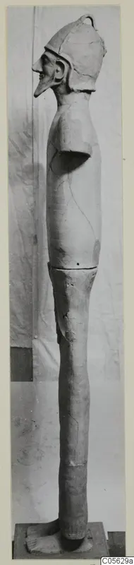 Terracotta Proto-Cypriote II figure, tall and slender, shown in profile wearing a helmet-like cap.