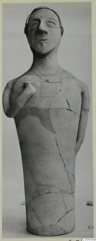Terracotta standing human figure with one arm bent up to the chest and the other hanging at the side, restored from pieces
