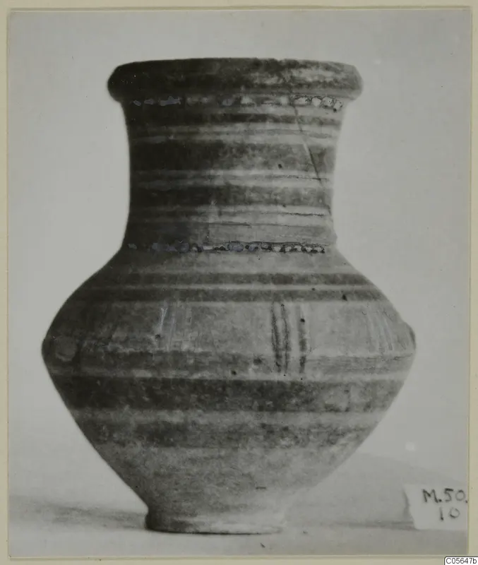 Pottery jar with a flared rim, narrow neck and horizontal bands, seen from the side