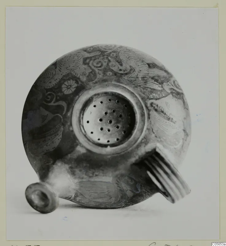 Round painted vessel with a perforated top and ribbed handle, from Marion