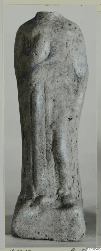 Headless terracotta figurine of a standing figure on a rectangular base, with traces of blue paint