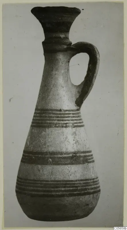 Pottery Black-on-Red II-IV juglet from Amathus with a flared neck, single loop handle and dark horizontal bands