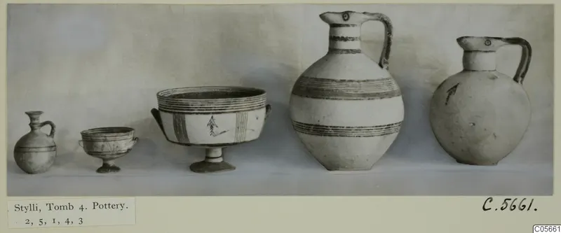 Five pottery vessels of different sizes standing in a row, from Stylli, Tomb 4