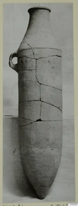 Pottery Plain White VII pithos: tall vessel with a pointed base and a small loop handle, cracked and repaired
