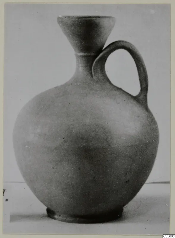 Jug of Stroke Polished Ware with a funnel-shaped mouth and single loop handle, from Marion tombs 46–60