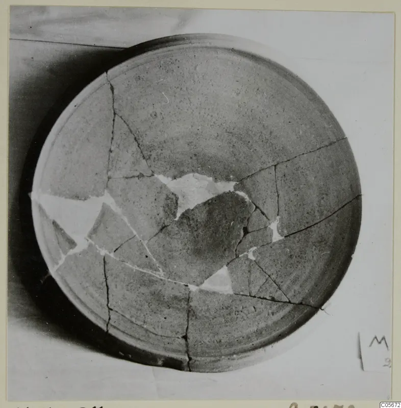 Pottery Plain White VII bowl, broken and mended with white filler, seen from above.