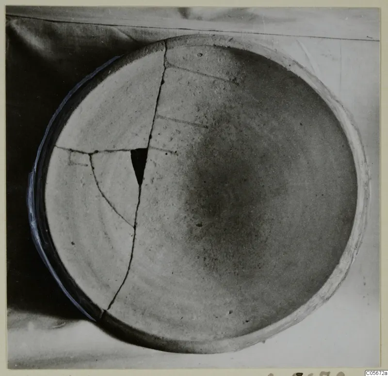 Pottery Plain White VII, a shallow bowl seen from above, broken and mended with visible cracks across its interior.