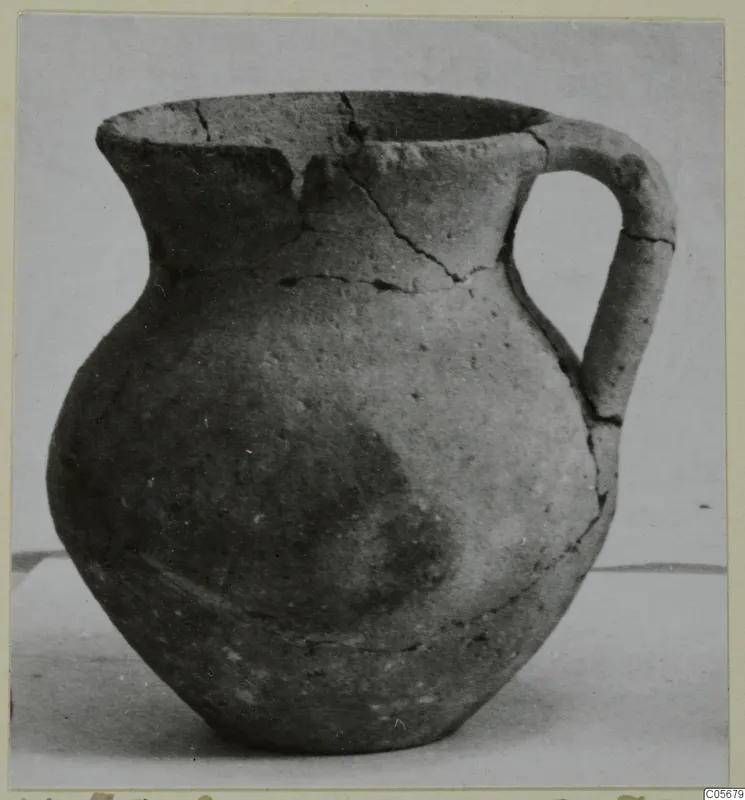 Pottery jug with a single handle and a wide mouth, cracked across the neck and shoulder