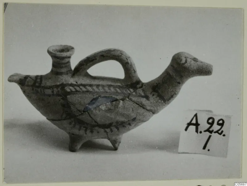 Small bird-shaped clay vessel with a loop handle and painted bands, from Amathus tombs 10–26