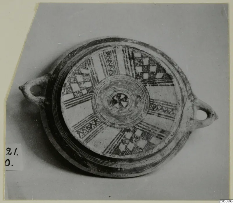 Pottery Bichrome II plate from Amathus seen from above, with radiating painted bands and checkerboard panels