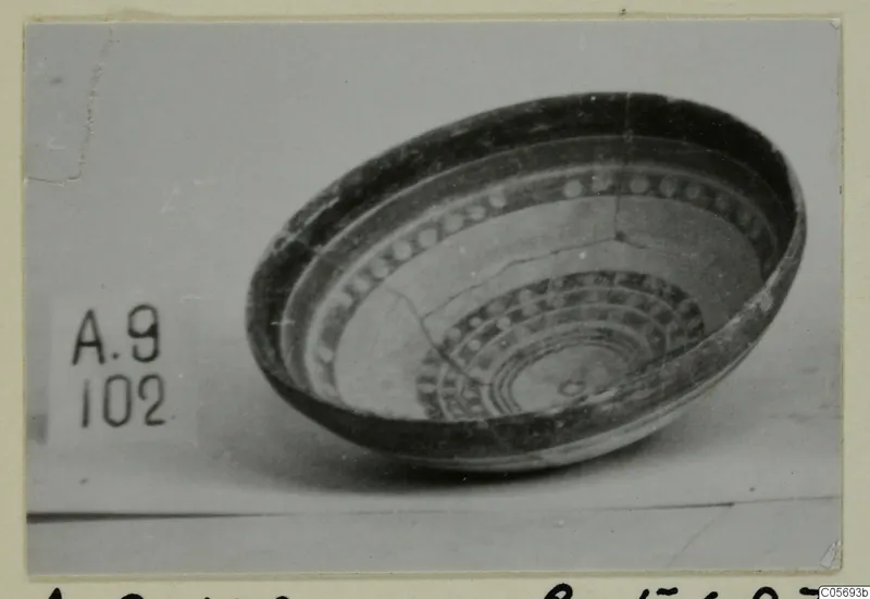 Pottery Polychrome bowl from Amathus, shown tilted to reveal concentric bands and dotted decoration inside.