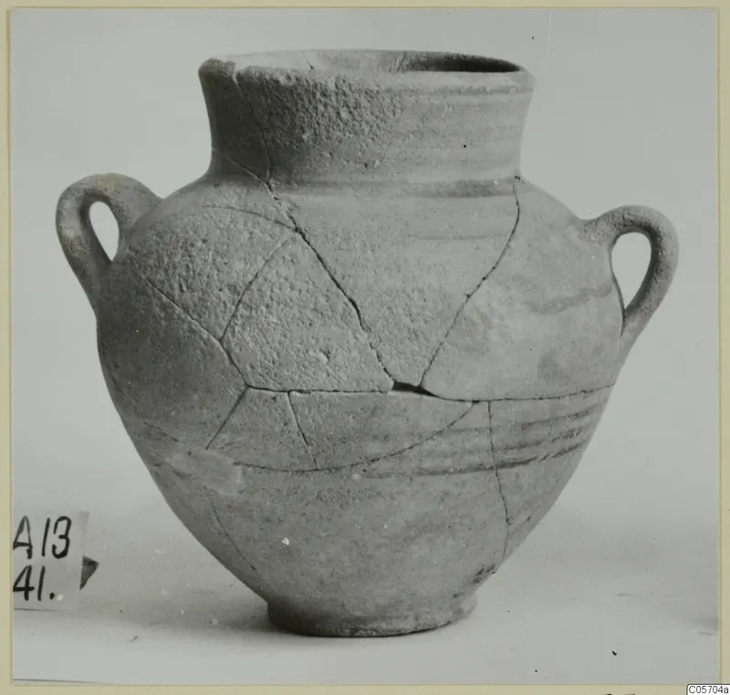 Two-handled pottery jar from Amathus, with cracks repaired, shown in side view against a pale background