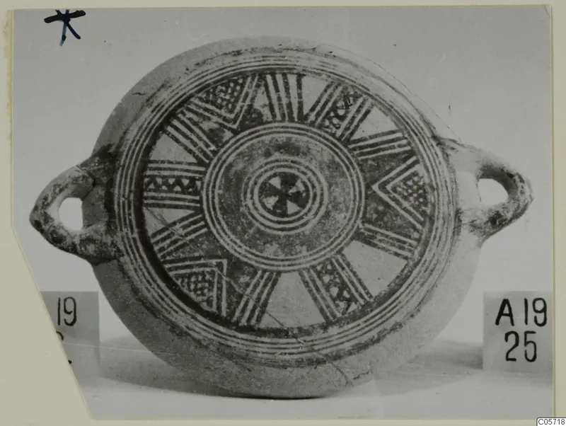 Pottery Bichrome II plate with two loop handles and painted concentric rings and radiating bands