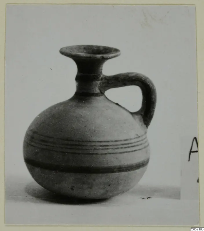 Pottery White Painted IV juglet from Amathus, with a flaring rim, single handle and dark painted bands