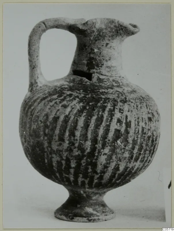 Black Slip I-VI jug from Amathus with a single loop handle and vertical striped decoration
