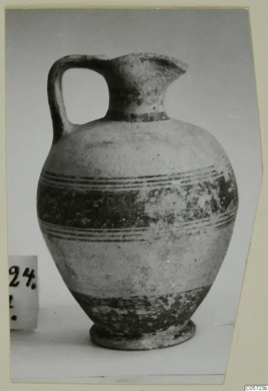 White Painted I jug with a strap handle, a trefoil-type spout and dark painted bands around the body