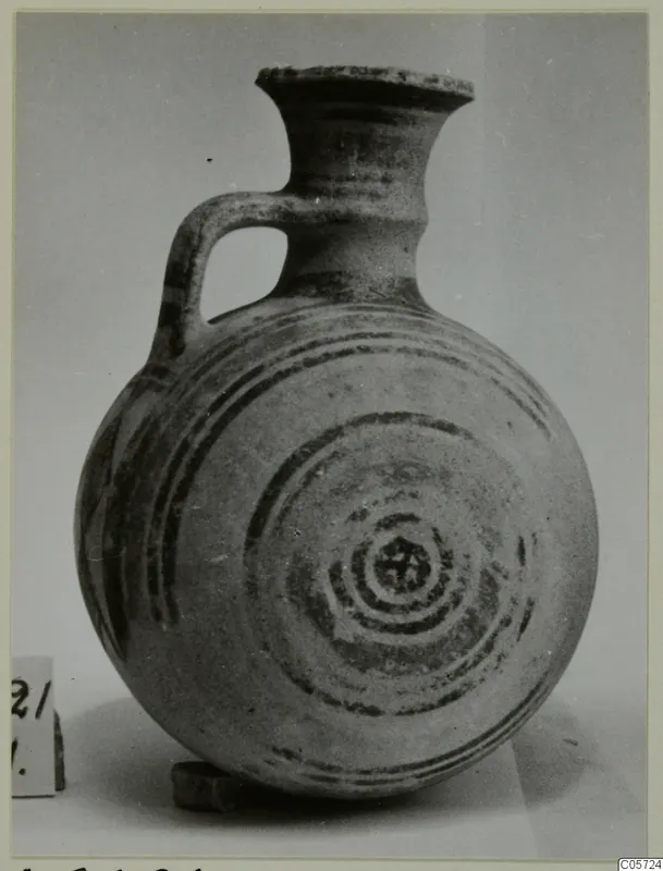 Pottery Bichrome I jug from Amathus, round body with concentric dark bands painted on it and a single loop handle.