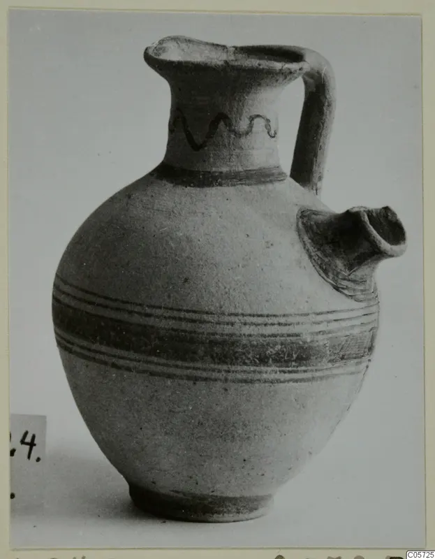 Pottery Bichrome I jug from Amathus with a painted wavy line on the neck and bands around the body