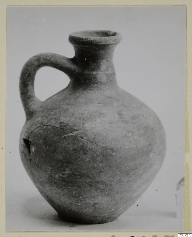 Pottery jug with a flared rim, single loop handle and rounded body, from Amathus