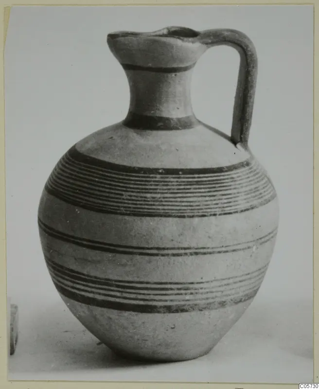 Pottery Black-on-Red I-III jug with one handle and dark painted horizontal bands