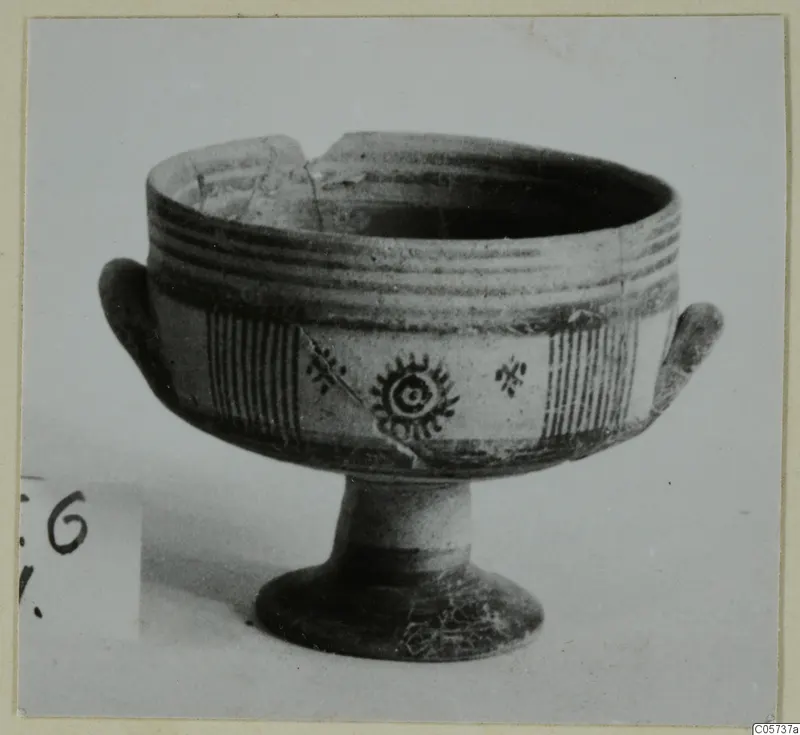 Pottery Bichrome III bowl on a pedestal foot, with painted bands, hatched panels and a rayed central motif.