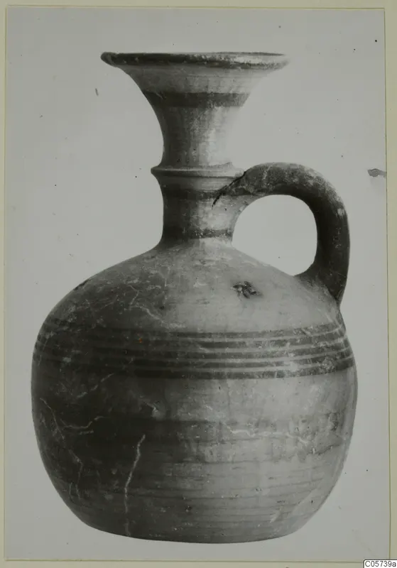 Pottery Black-on-Red I-III juglet from Amathus, with a flaring mouth, ridged neck and strap handle