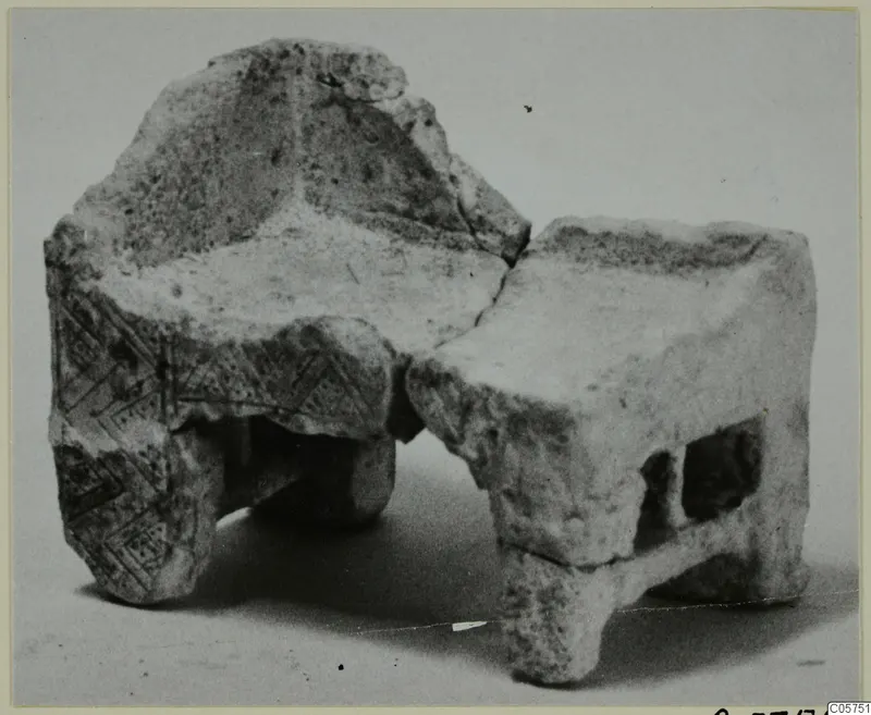 Fragmentary stone object from Marion with an incised pattern of diagonal lines and two rectangular openings.