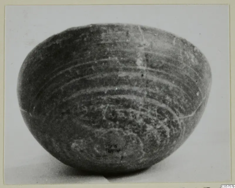 Foreign Red Slip bowl with concentric banded decoration around its rounded body, seen from the side