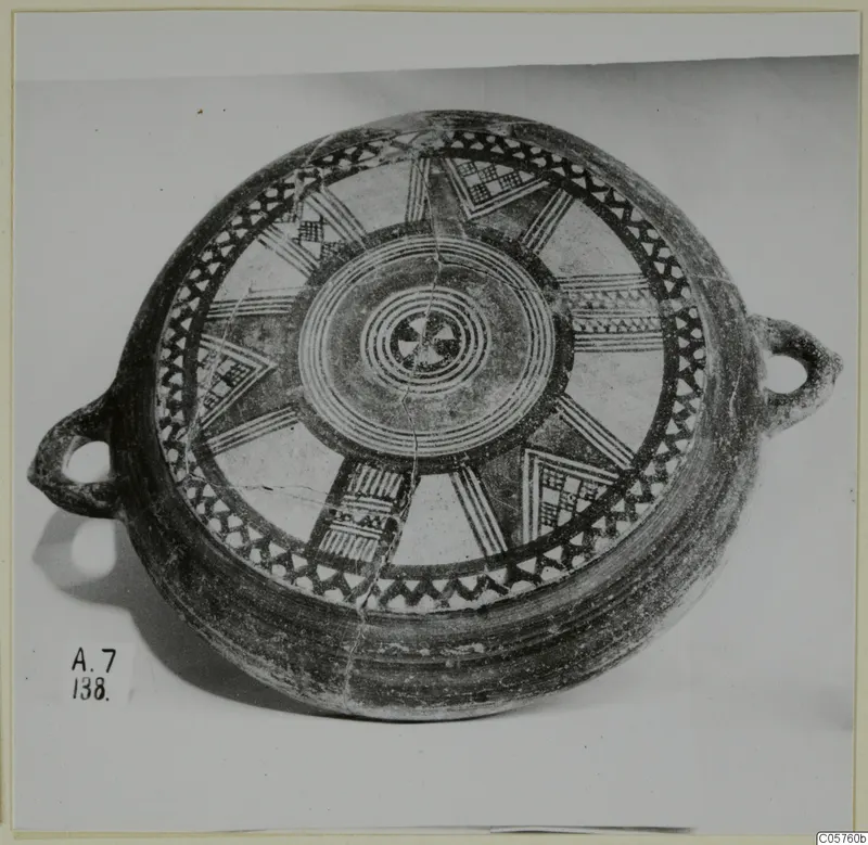 Pottery Black Slip Bichrome bowl with two loop handles, decorated with radiating bands and concentric circles