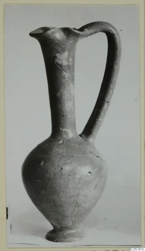 Pottery jug with a tall neck, pinched lip and strap handle, from the Amathus tombs series