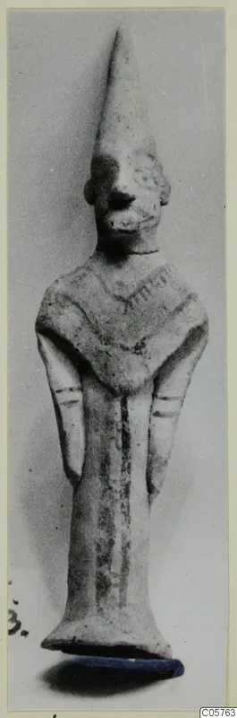 Terracotta figurine of a standing figure with a tall conical headdress, from Ayia Irini