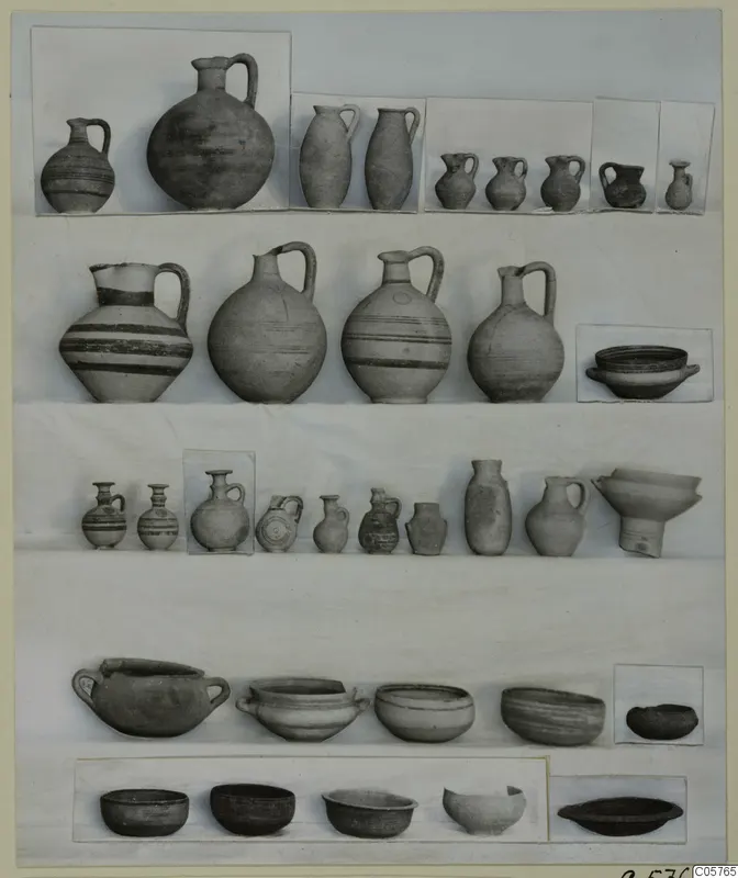 Pottery of Period 4 from Ayia Irini: jugs, juglets, bowls and pots arranged in rows on a board