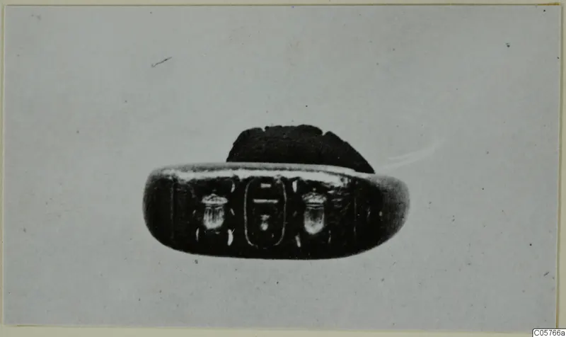 Oval engraved seal with two beetle-like figures flanking a central motif, shown in close view