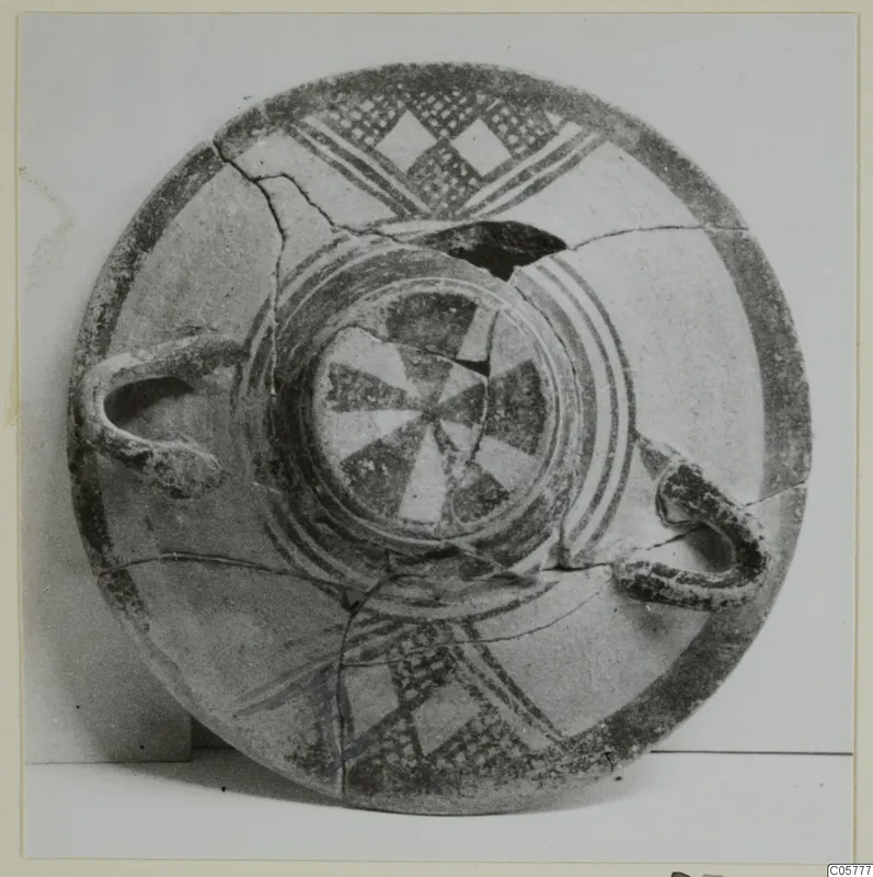 Pottery White Painted I bowl with dark bands, lattice and diamond motifs, and a central wedge pattern, seen from above.
