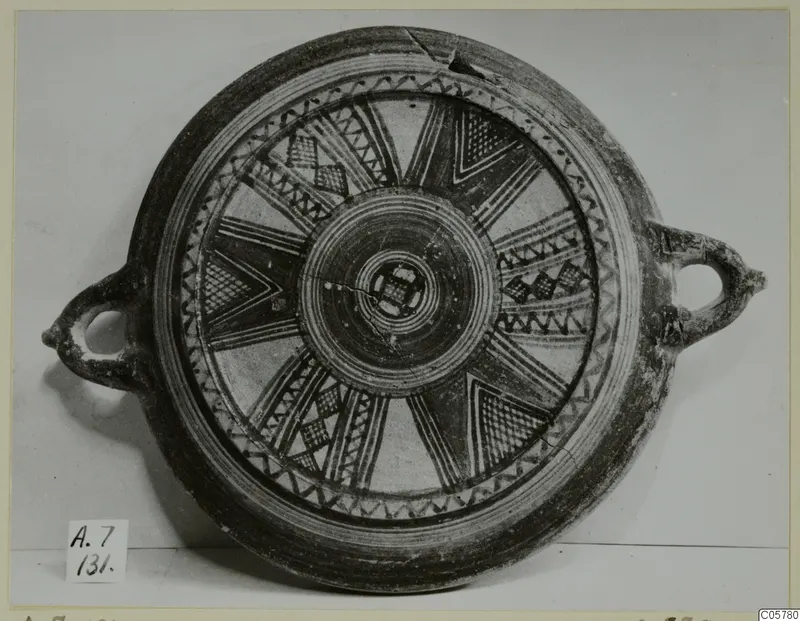 Pottery Bichrome III dish with two loop handles and a radiating painted pattern