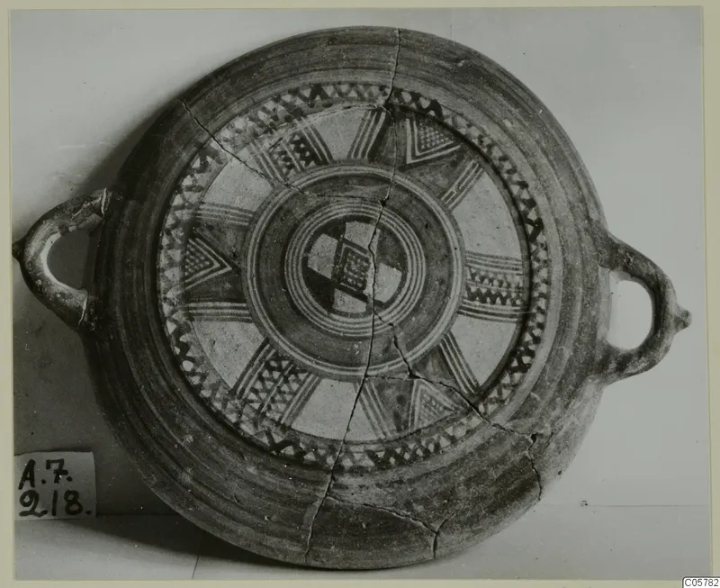 Pottery White Painted II: a shallow round vessel with two loop handles, seen from above, with dark painted bands and triangles