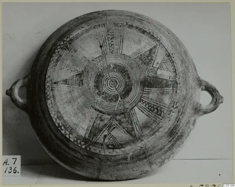 Black Slip Bichrome plate from Amathus, seen from above, with radiating painted bands, concentric circles and two loop handles
