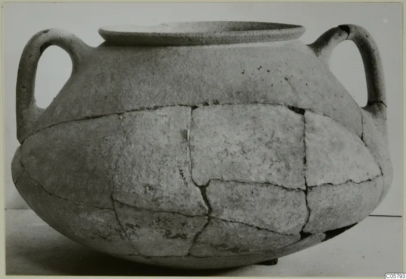 Two-handled crater in pottery, reconstructed from joined fragments, shown in side view against a plain background.
