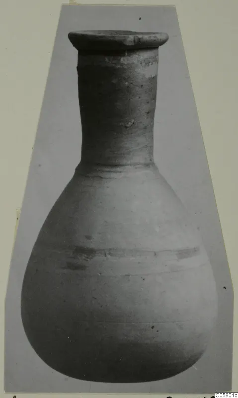 Pottery unguentarium from Amathus with a flaring rim, long narrow neck and rounded body, shown upright