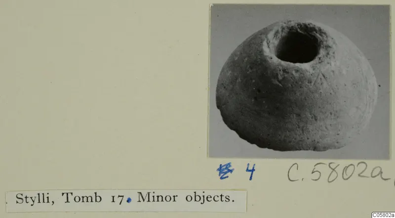 Rounded stone object with a wide circular opening in its top, from Stylli Tomb 17.