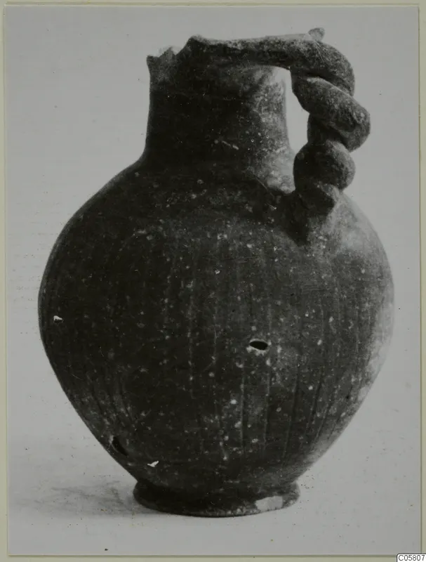 Pottery Black Slip Ware jug with a twisted handle and broken rim, from Amathus