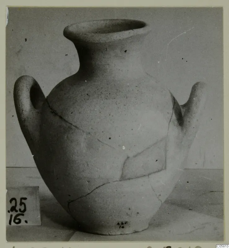 Pottery vessel with a wide mouth, two handles and a cracked body, photographed from the Amathus tombs series.