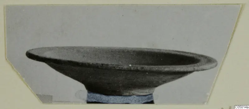 Pottery Red Slip bowl with a wide, flaring rim, photographed from the side